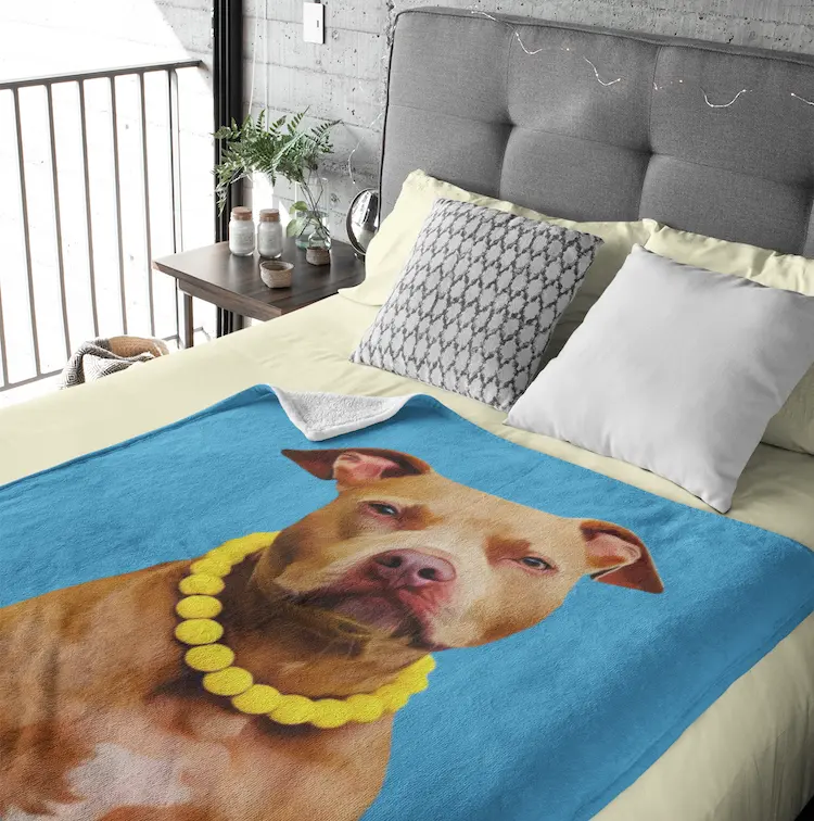 A large-size custom pet portrait blanket to make your bed more personal and cozy.