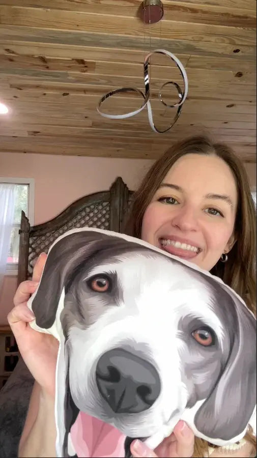 Custom shaped pet portrait pillow by Paw-Pixie, held by a smiling customer.