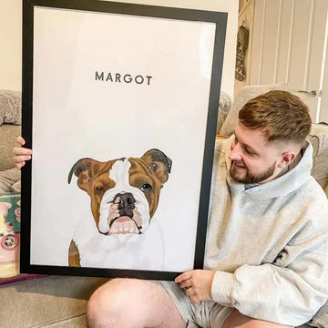 A man holding a large custom pet portrait frame by Paw-Pixie, featuring his bulldog named Margot.