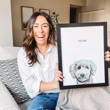 A happy customer with a custom pet portrait frame by Paw-Pixie, a cherished memory of her pet.