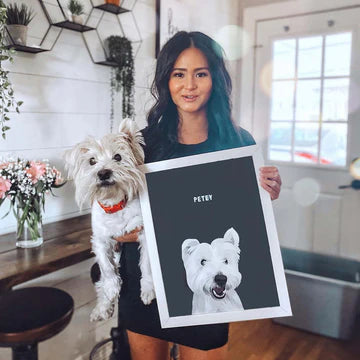 A woman holding a personalized pet portrait frame by Paw-Pixie, capturing the love for pets.
