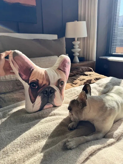 Custom pet portrait pillow from Paw-Pixie, featuring a bulldog’s face in a cozy bed setting.